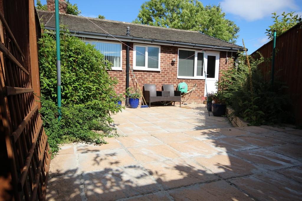 A charming garden area featuring a spacious pat...