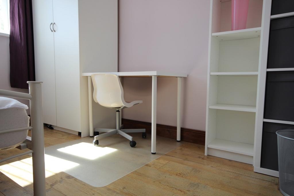 This inviting double bedroom features a comfort...