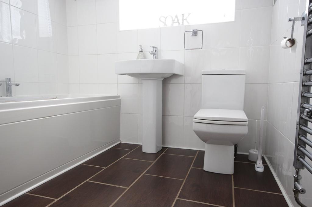 A stylish bathroom suite featuring modern fixtu...