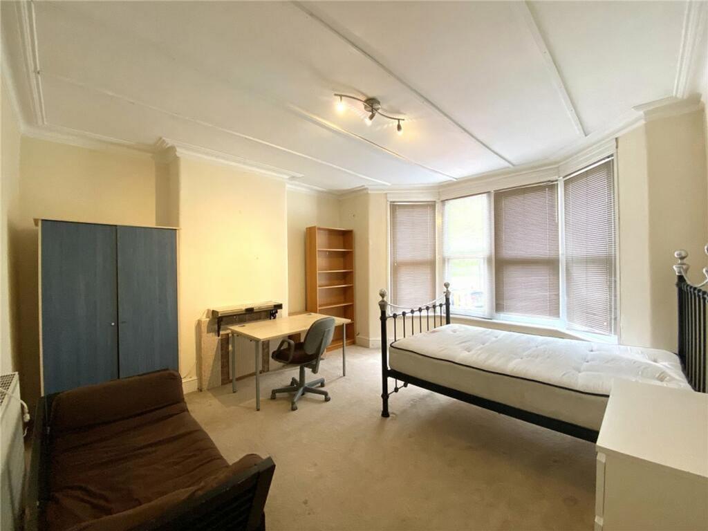 Spacious double bedroom featuring ample natural...