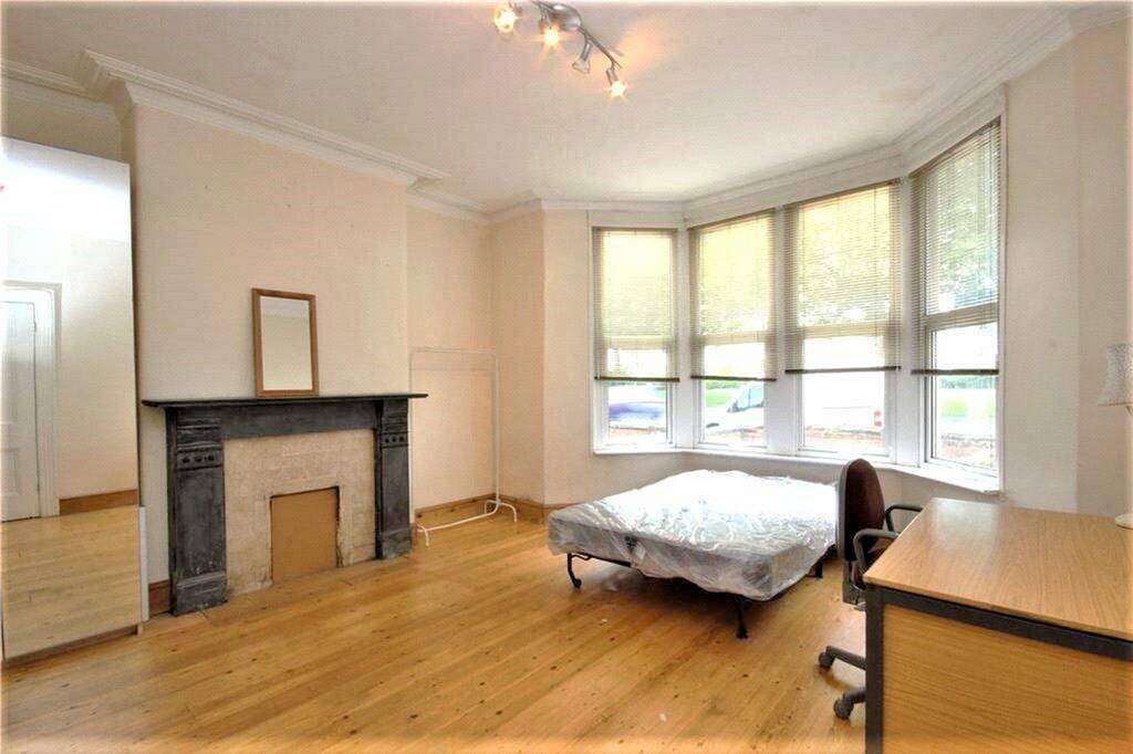 Spacious double bedroom featuring large windows...