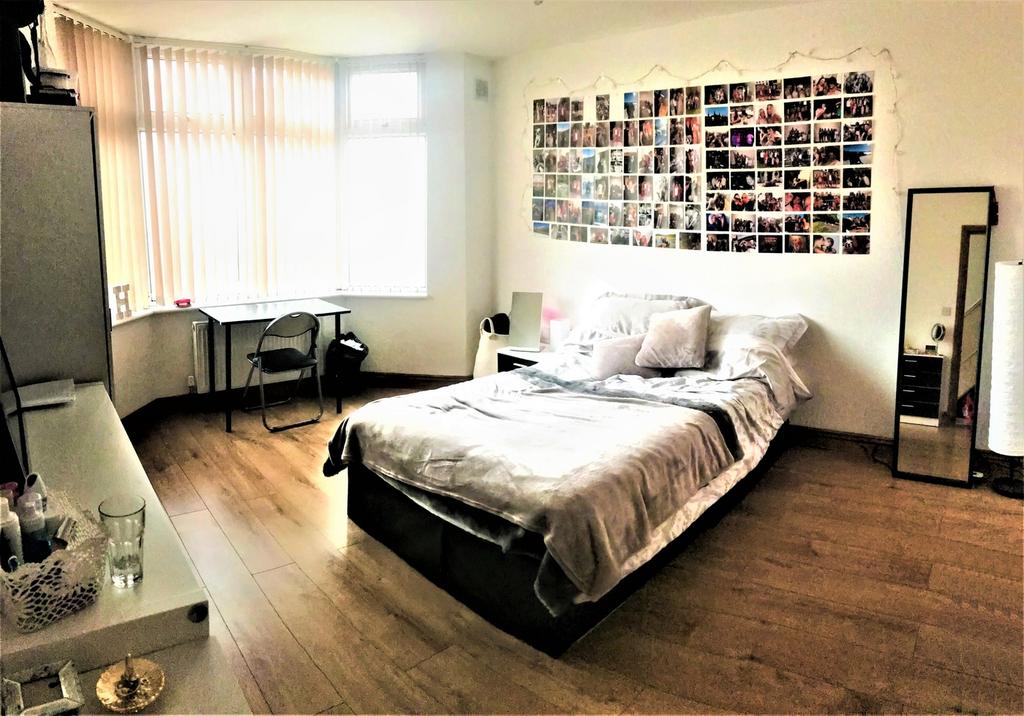Spacious double bedroom featuring a comfortable...
