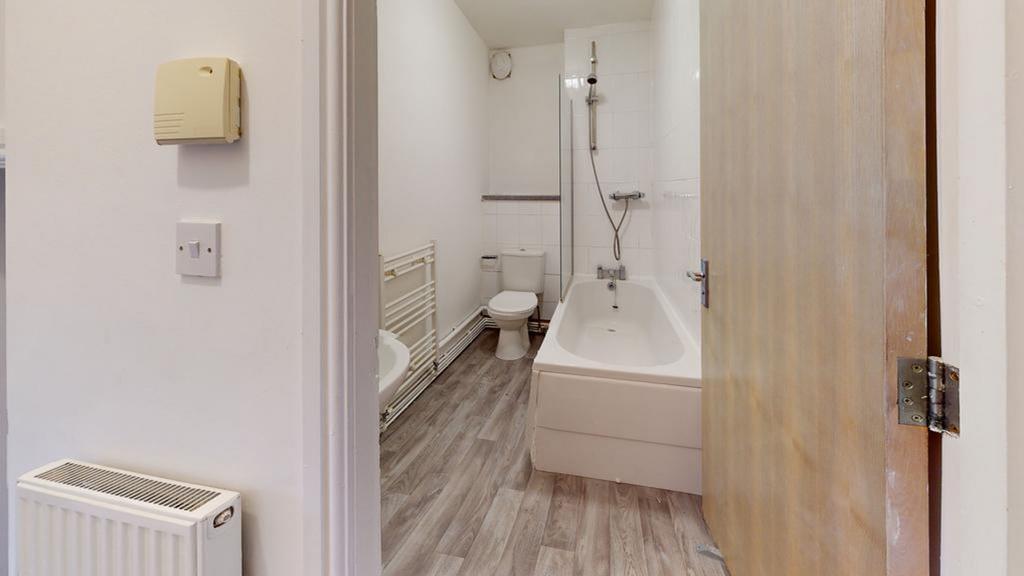 A modern bathroom featuring a bath and shower, ...