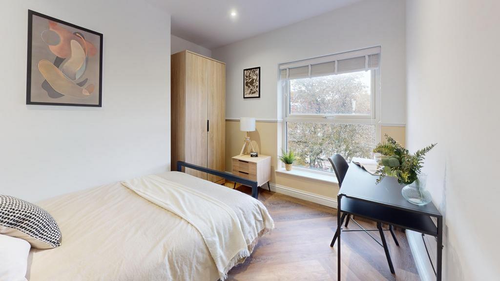 A bright and inviting double bedroom featuring ...