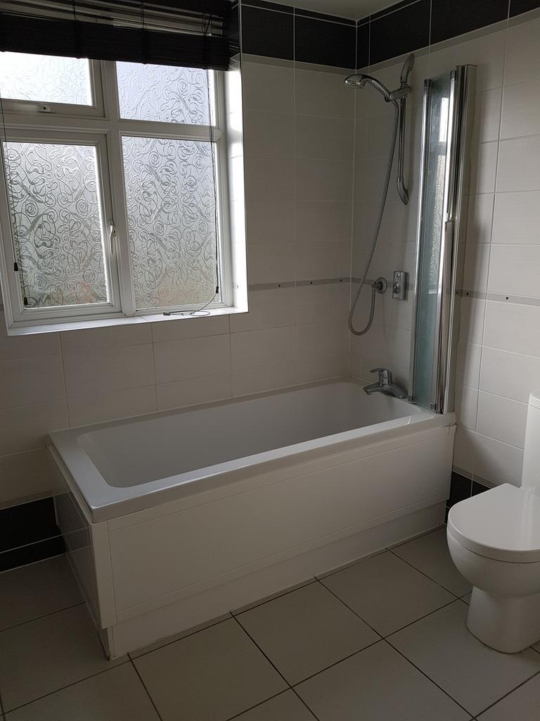 A bright and modern bathroom featuring a clean ...