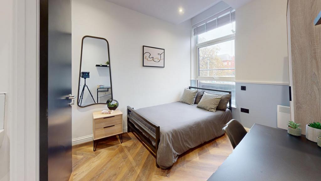A stylish and well-lit double bedroom with mode...