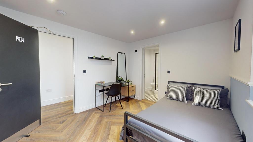 A stylish and well-lit double bedroom featuring...