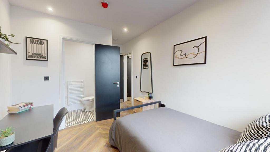 A bright and inviting double bedroom featuring ...