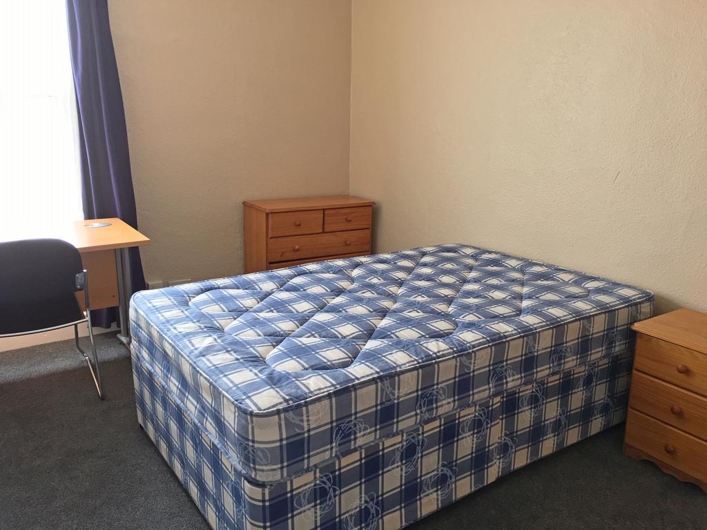 A cozy double bedroom featuring a comfortable m...