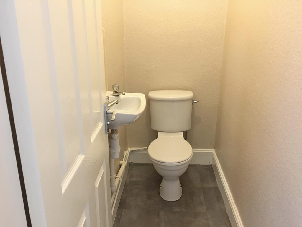 This compact single toilet features a clean and...