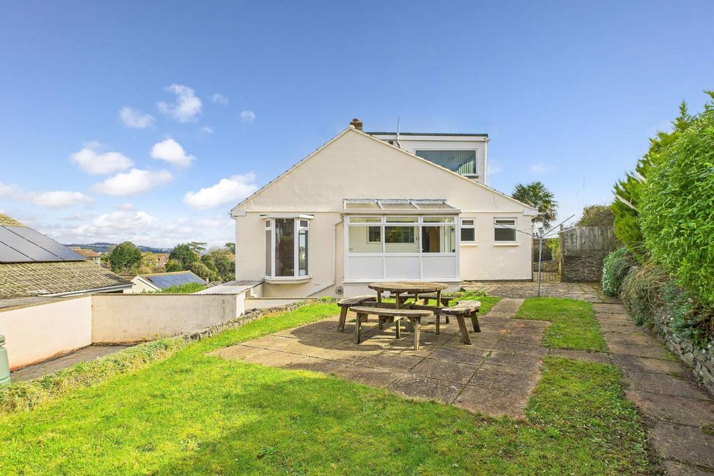 Rear garden with patio, lawn, and house exterior v