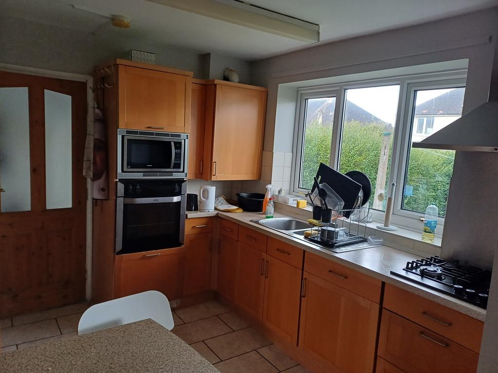 This inviting kitchen features ample wooden cab...