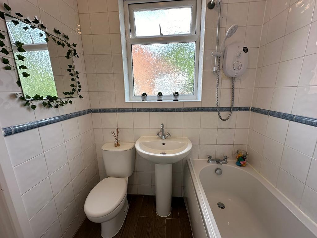 This well-maintained bathroom features a modern...