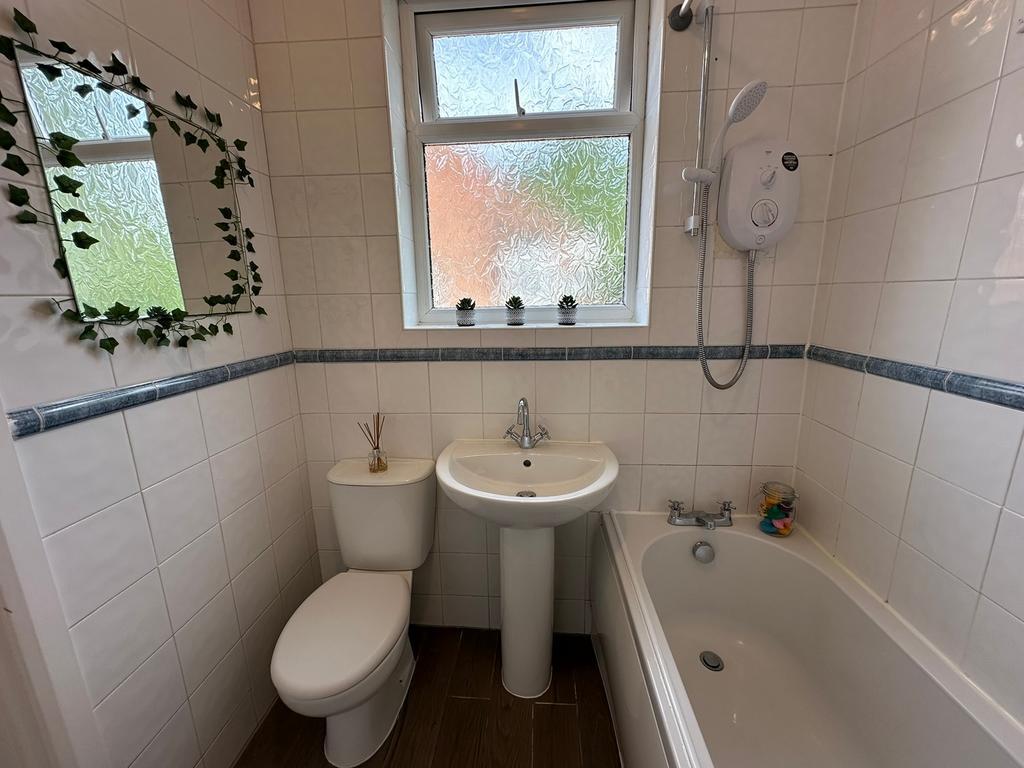 A well-maintained bathroom featuring a bathtub ...