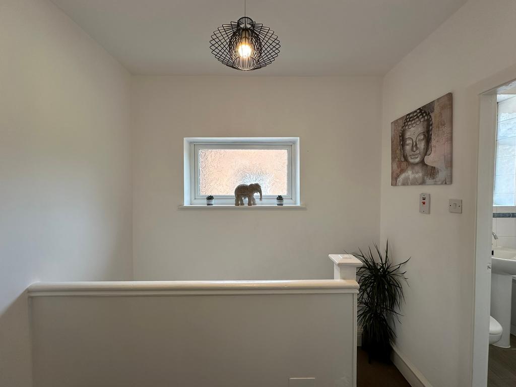 Bright and inviting hallway featuring modern de...
