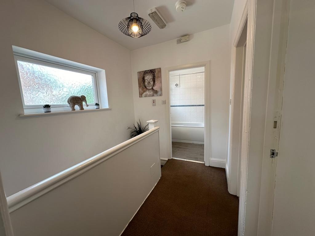 Welcoming hallway featuring natural light from ...