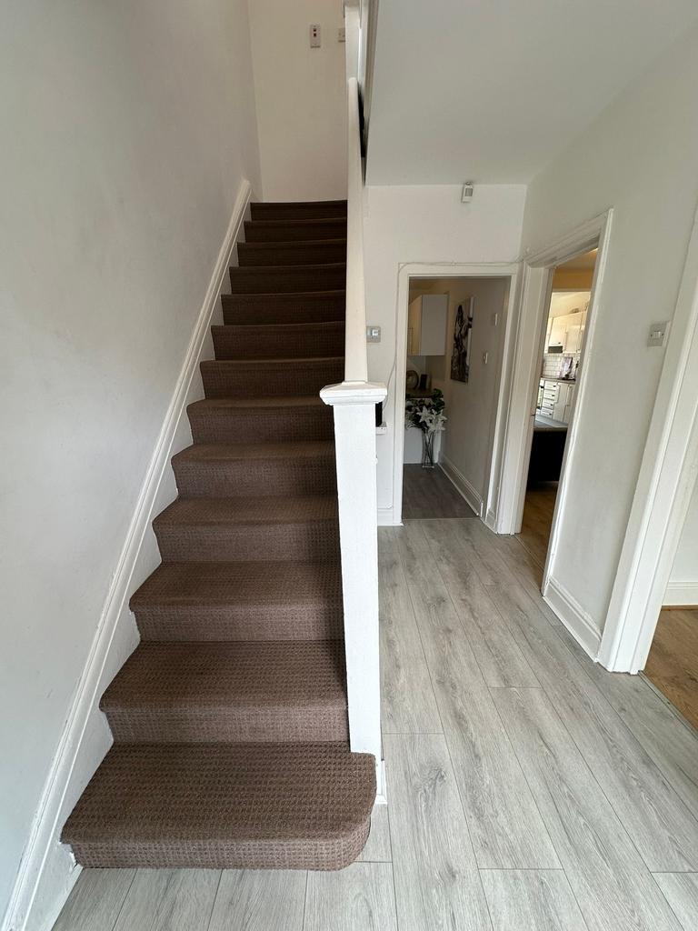 A well-maintained staircase leading to upper le...