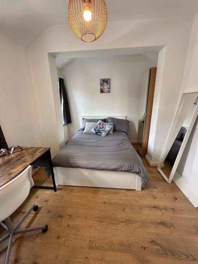 This cozy double bedroom features a comfortable...