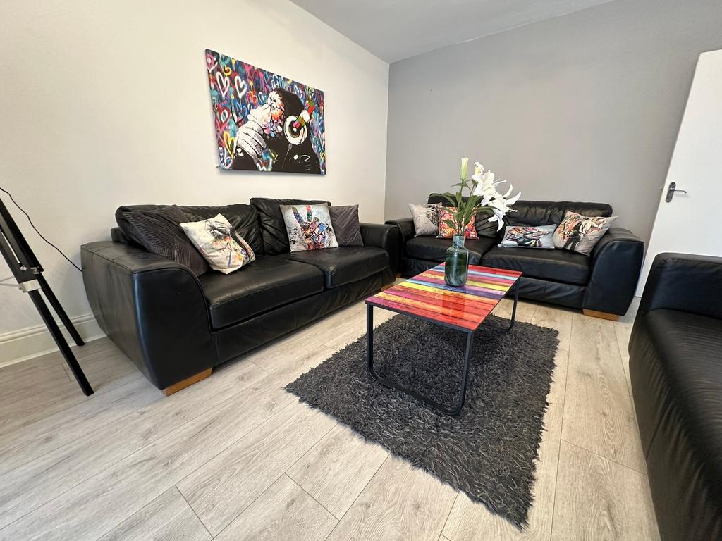 A stylish living room featuring comfortable bla...