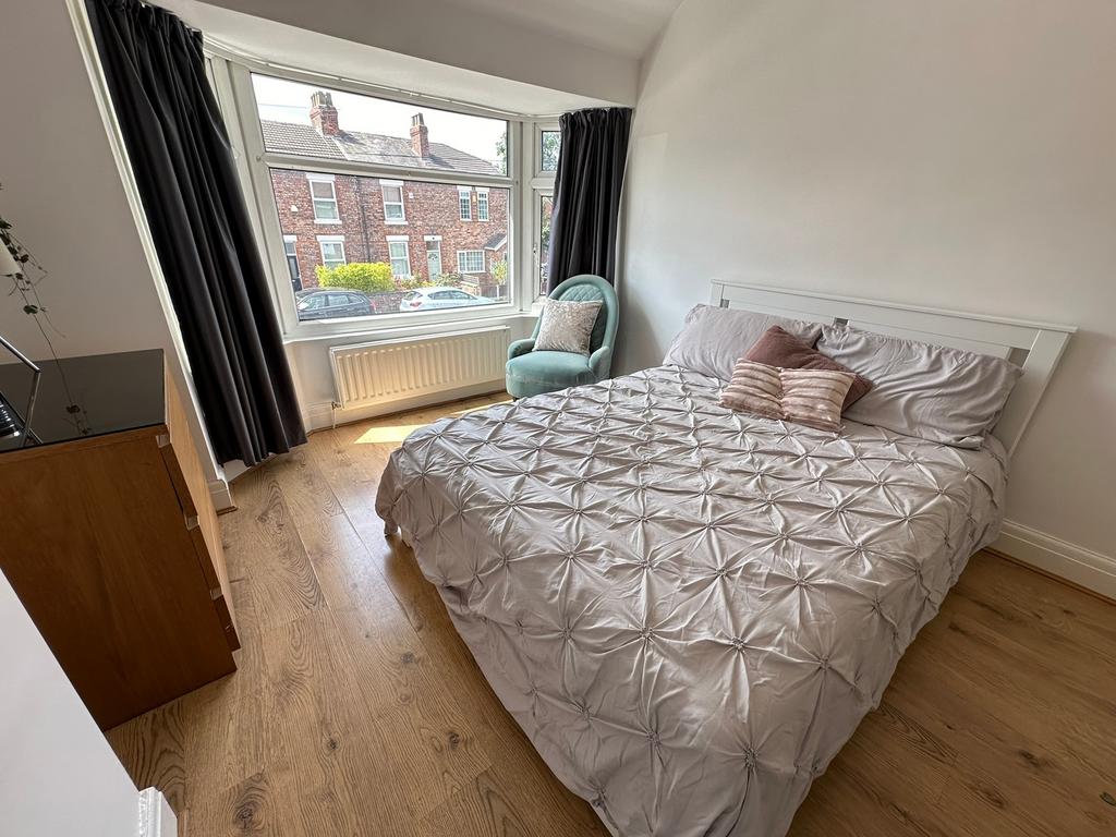 Bright and spacious double bedroom featuring a ...