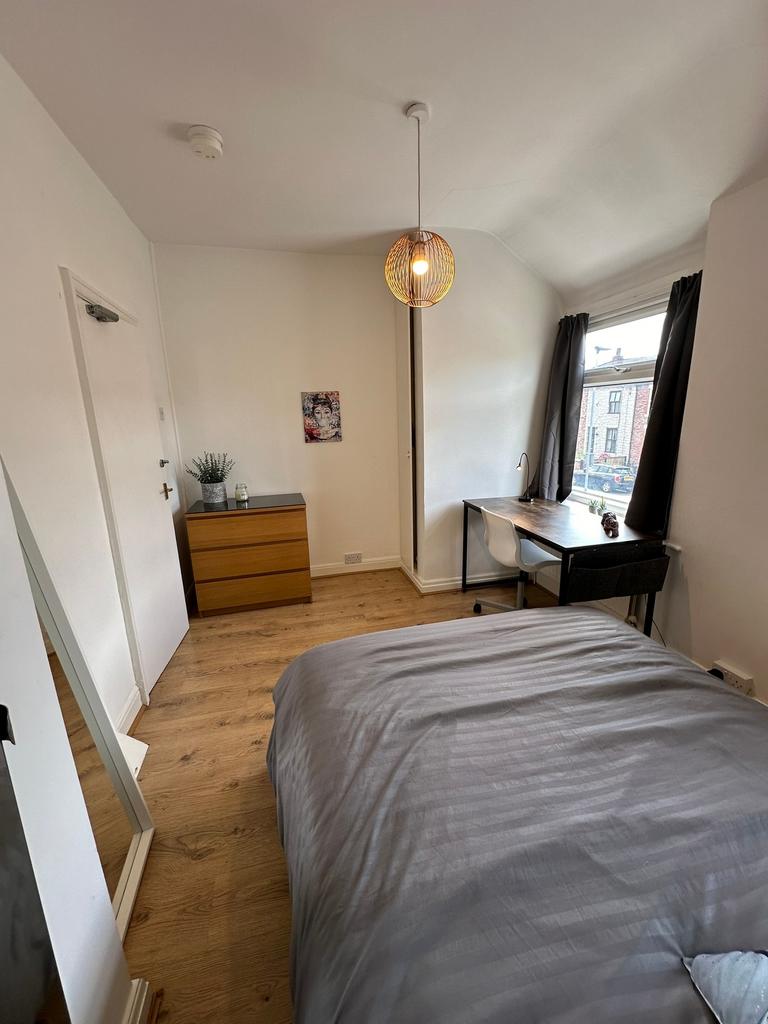 This inviting double bedroom features a cozy la...