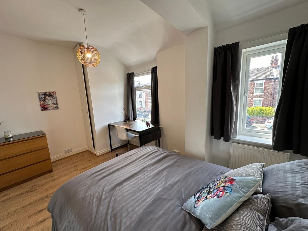 A beautifully styled double bedroom featuring a...
