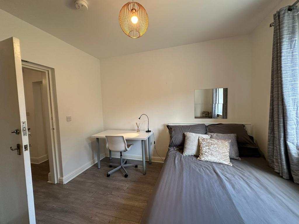A beautifully designed double bedroom featuring...