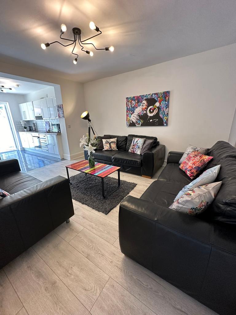 A stylish living room featuring comfortable bla...