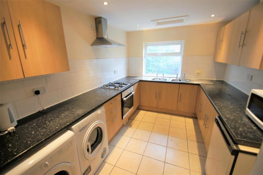 A well-equipped kitchen featuring modern applia...