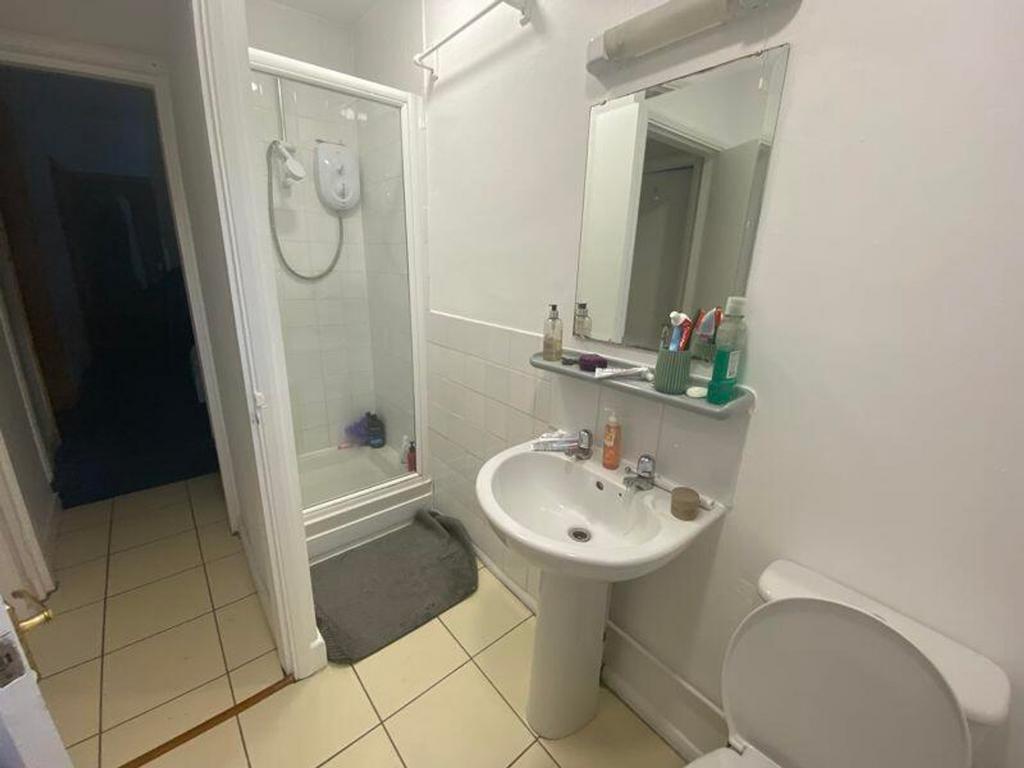 A tidy and functional bathroom featuring a show...