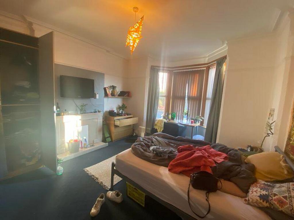 A cozy double bedroom with ample natural light ...