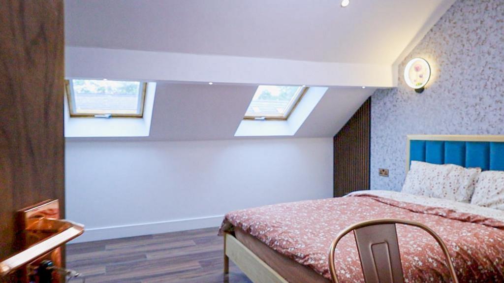 A spacious and inviting double bedroom featurin...