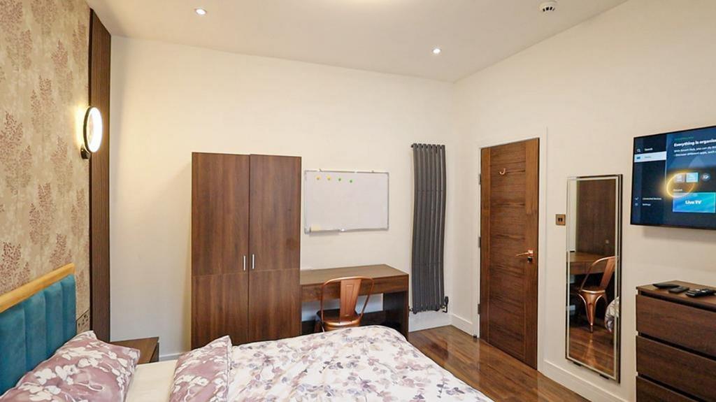 A bright and inviting double bedroom featuring ...