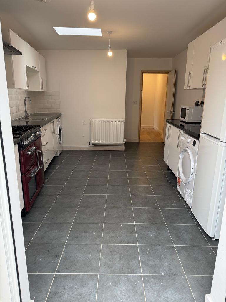 Spacious kitchen featuring modern appliances, a...