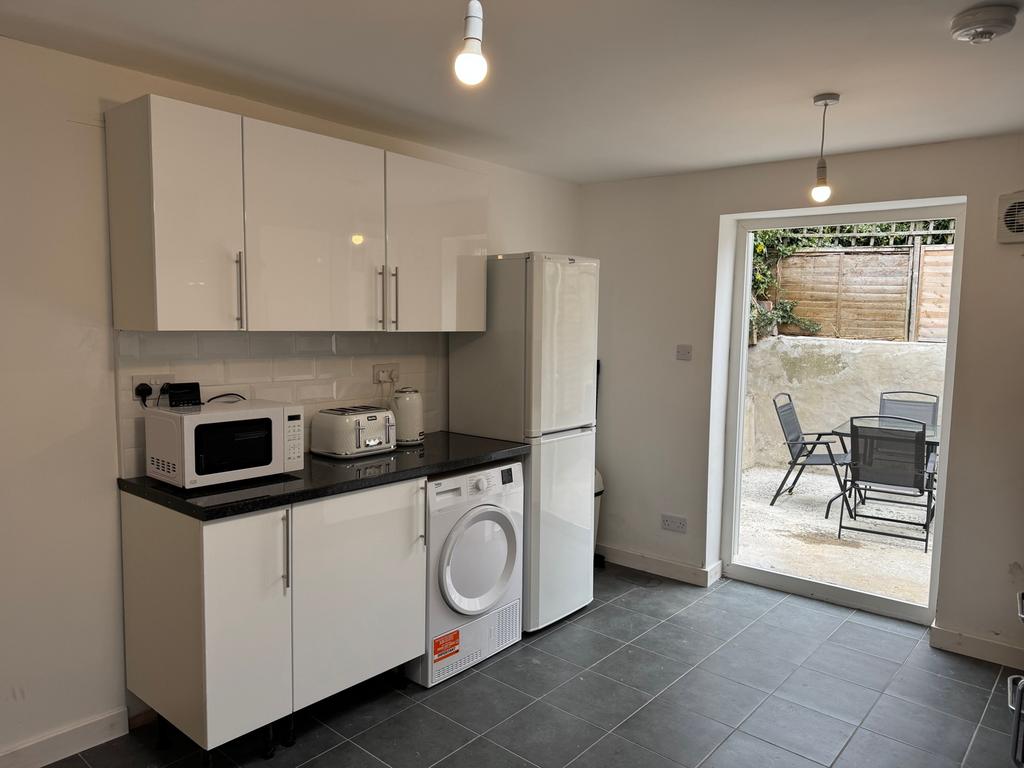 Modern and stylish kitchen featuring sleek cabi...