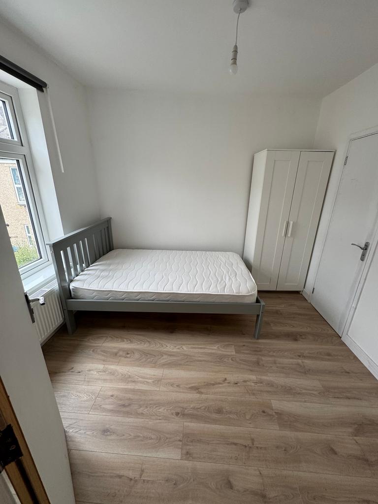 A bright and inviting double bedroom featuring ...