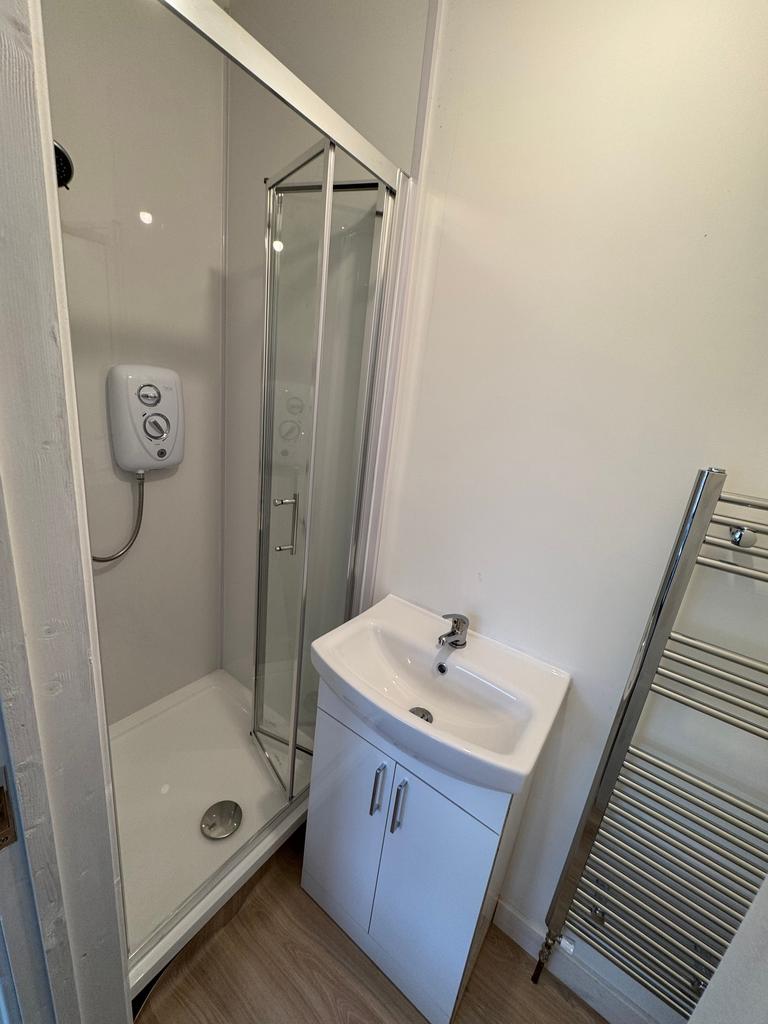 A modern bathroom featuring a sleek shower encl...
