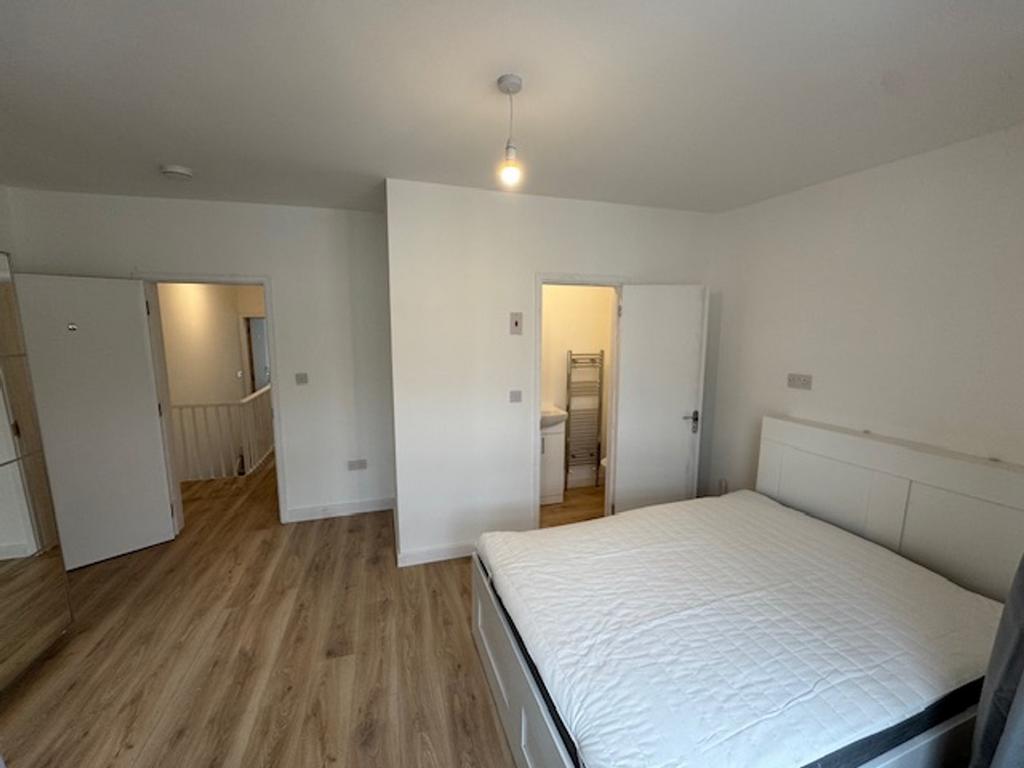 A bright and spacious double bedroom featuring ...