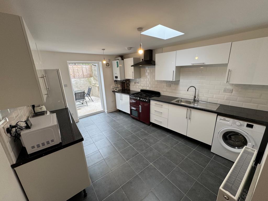 Modern kitchen featuring sleek cabinetry, ample...