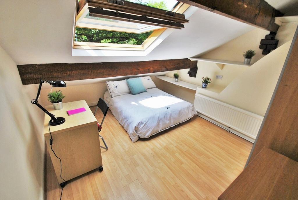 Bright and spacious double bedroom featuring a ...