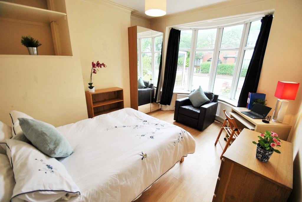 A bright and inviting double bedroom featuring ...