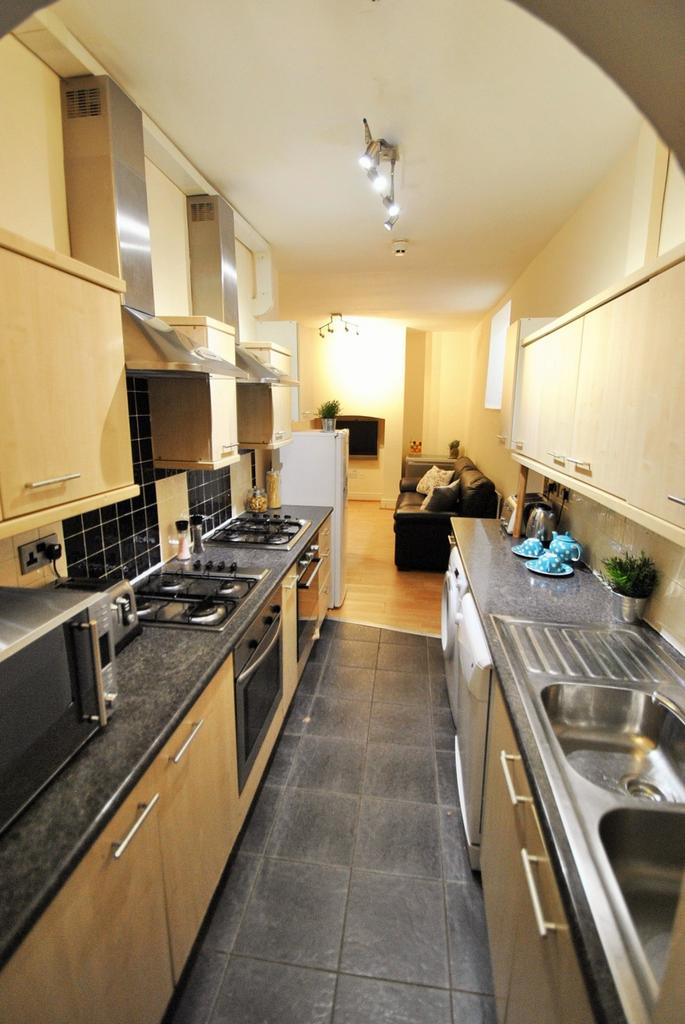 A modern kitchen featuring sleek cabinetry, amp...