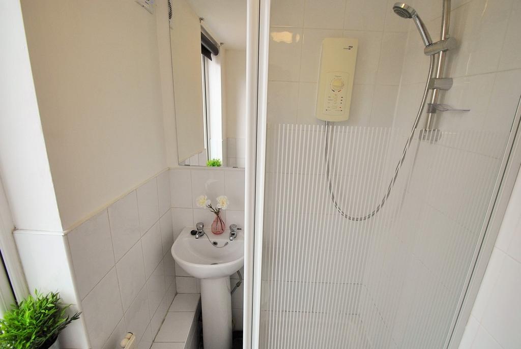 A modern bathroom featuring a sleek shower unit...