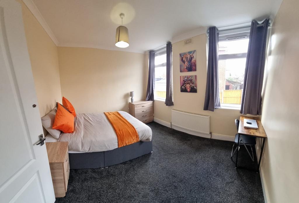 A cozy double bedroom featuring a comfortable b...
