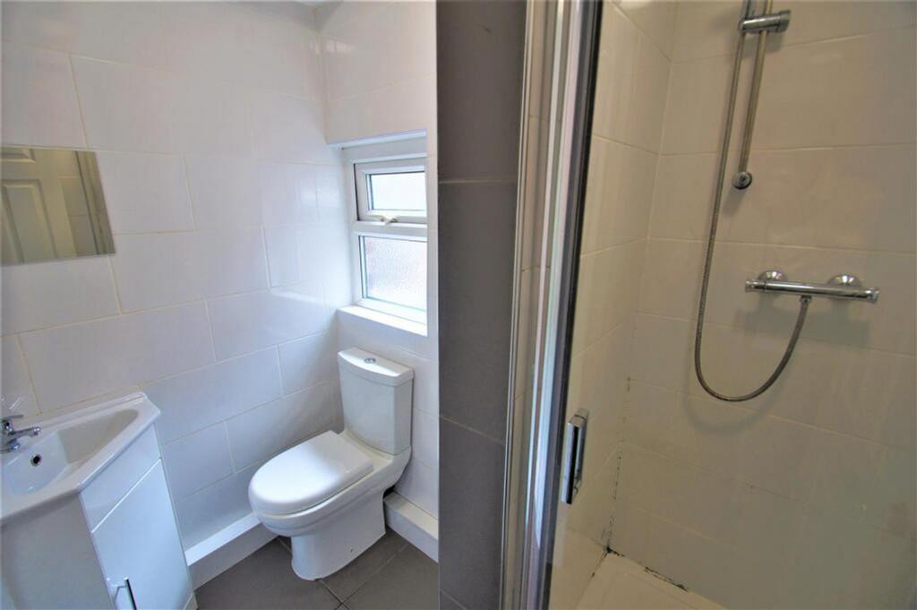 Bright and modern bathroom featuring a spacious...