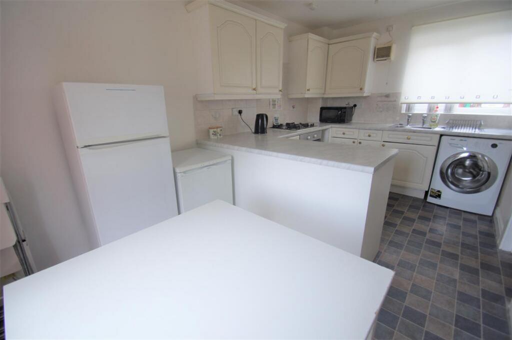 Bright and spacious kitchen featuring modern ap...