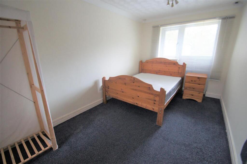 Spacious double bedroom featuring a comfortable...