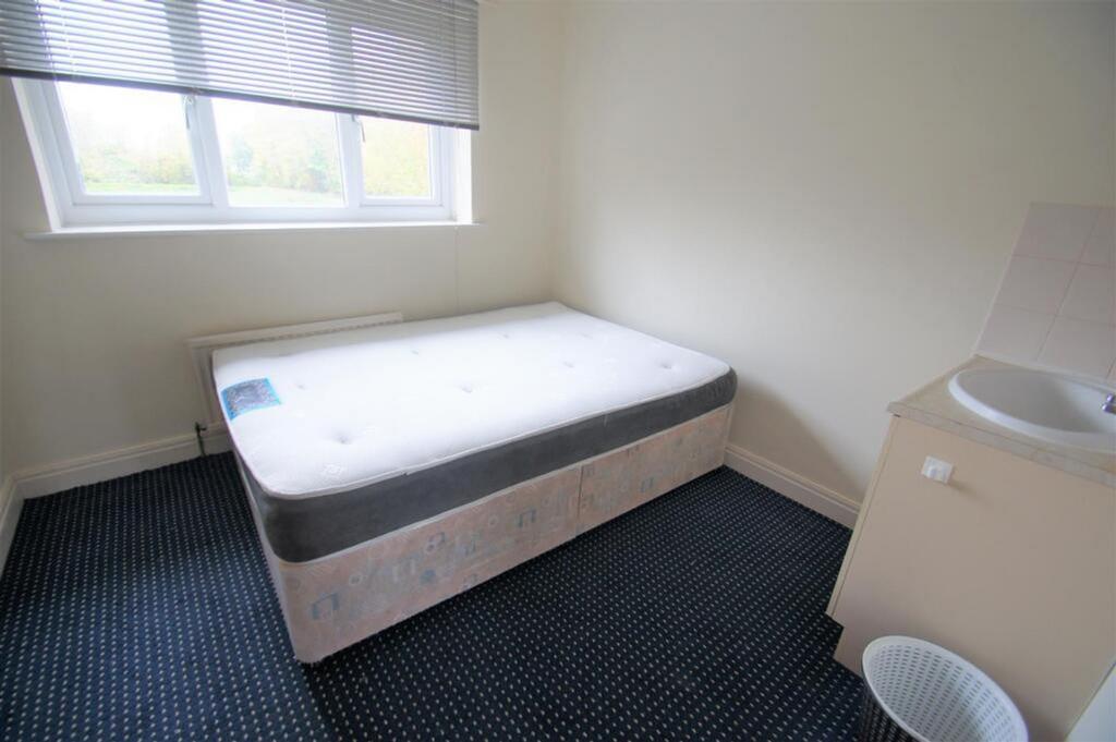 A bright and inviting double bedroom featuring ...