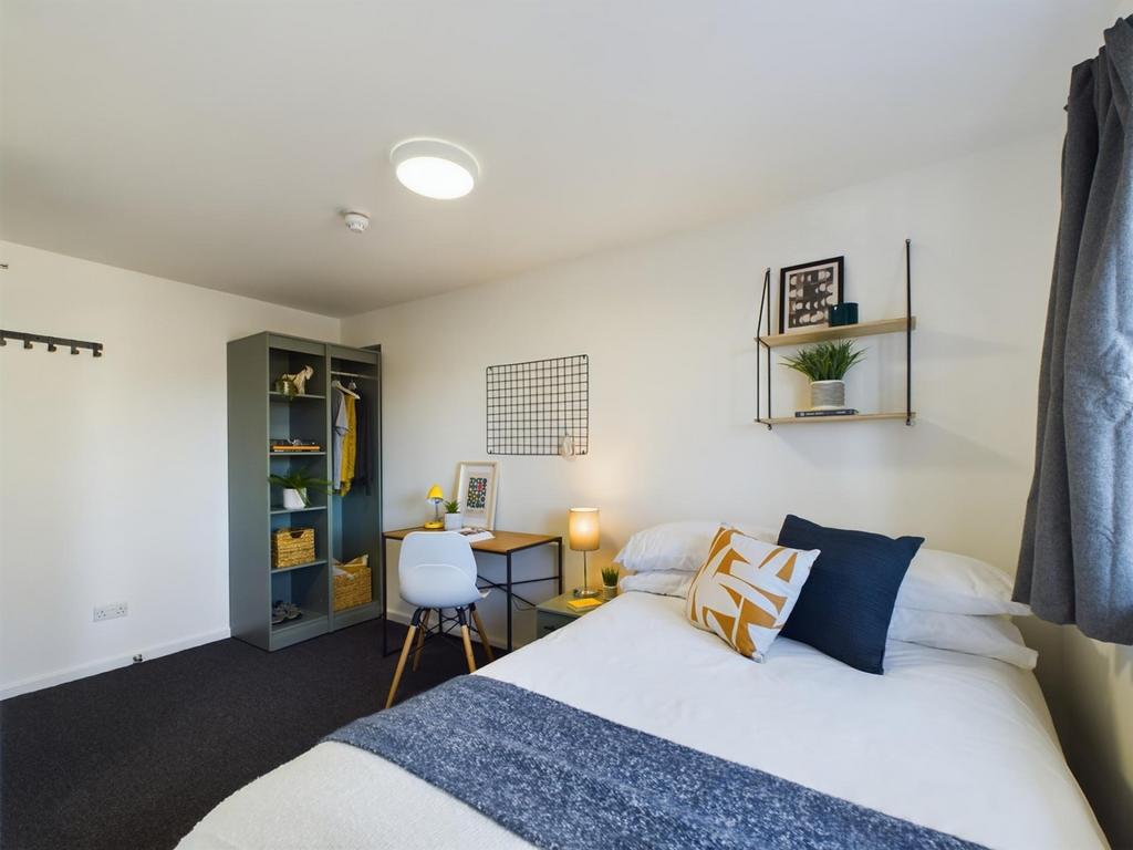 A bright and inviting double bedroom featuring ...