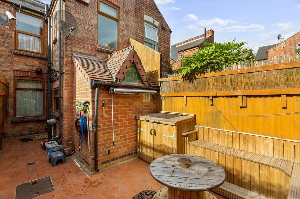 Charming outdoor garden space, featuring a cozy...